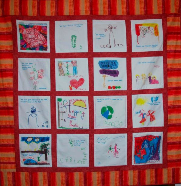 a peace quilt with squares hand-drawn by children