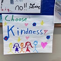Colorful poster by a child which reads, Choose Kindness.