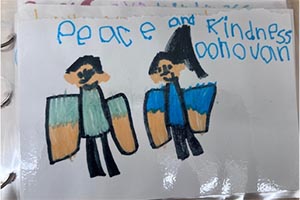 Colorful poster by a child which reads, Peace and Kindness.