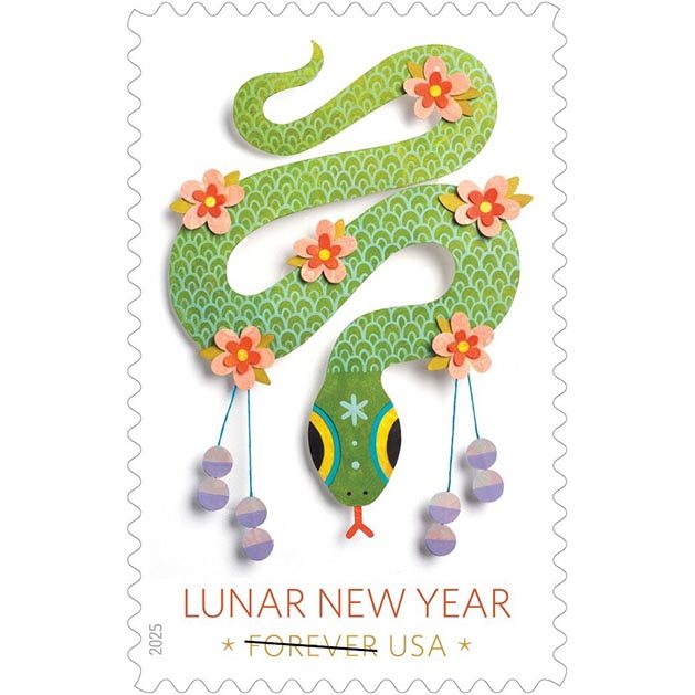 Paper cutout of a green snake in 4 S-curves. The snake is decorated with flowers and festive tassels for Lunar new year.