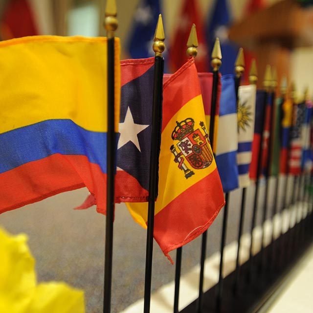 Miniature flags representing Hispanic nations line the stage during the 2012 Hispanic Heritage Month celebration