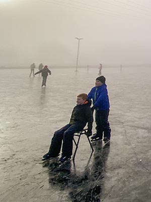 Children playing and skating on ice