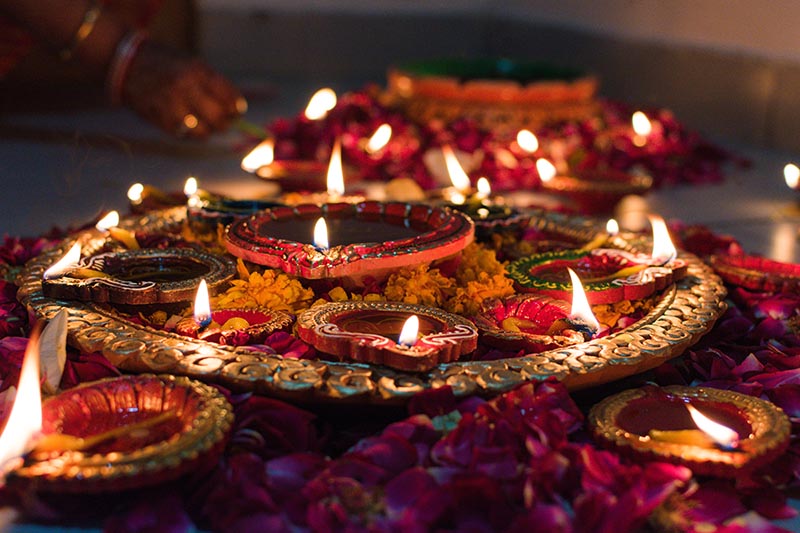 Bowl of lit candles celebrating Diwali