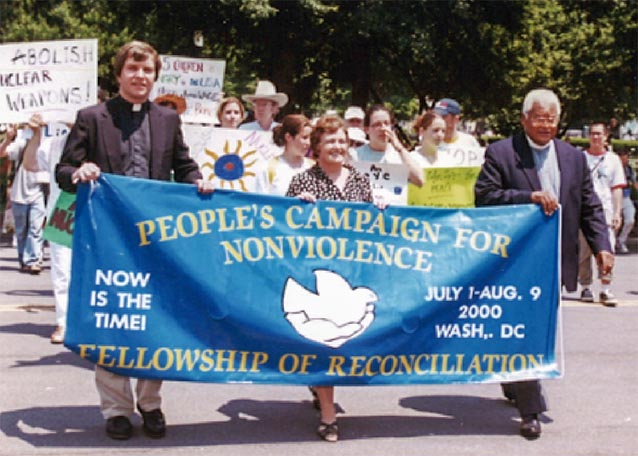 Group of marchers holding a 12-foot banner for the Fellowship of Reconciliation