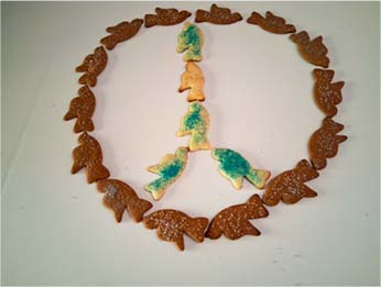 Cookies cut into the shape of doves are arranged into a peace symbol.