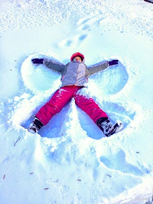 Child creating snow angels