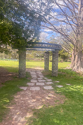 A stone archway over a dirt and stone path